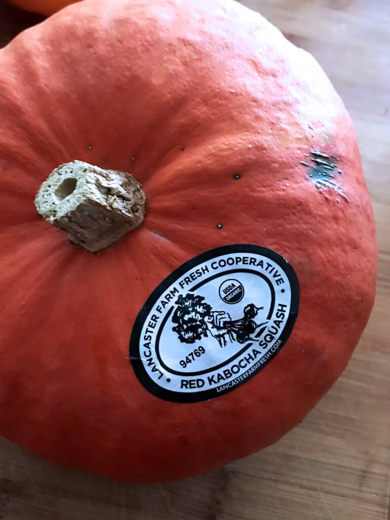 A red kabocha squash on a table.