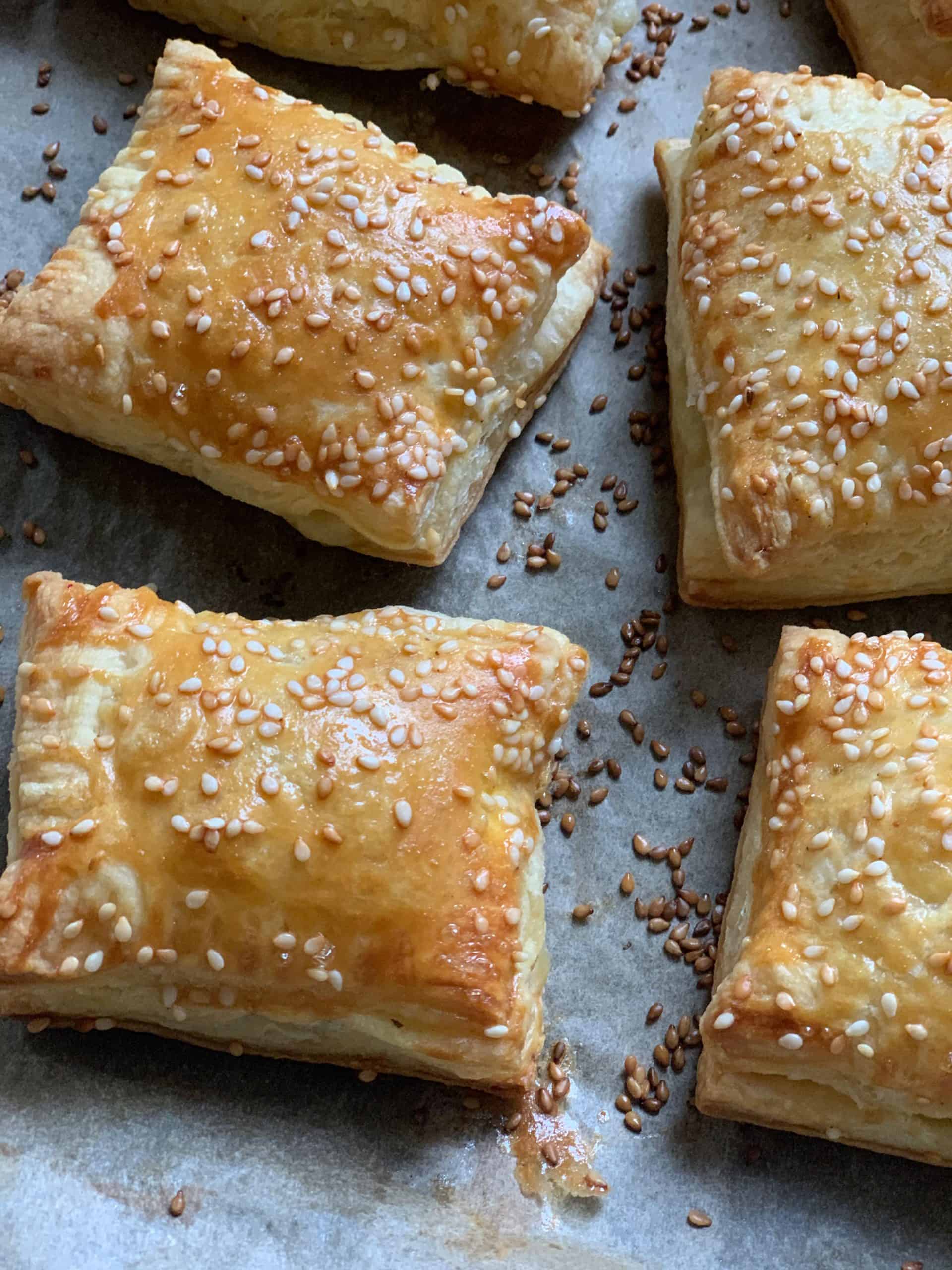 Cheese puff pastries on parchment paper.