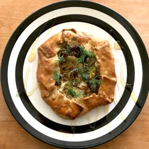A leek and potato galette on a plate.