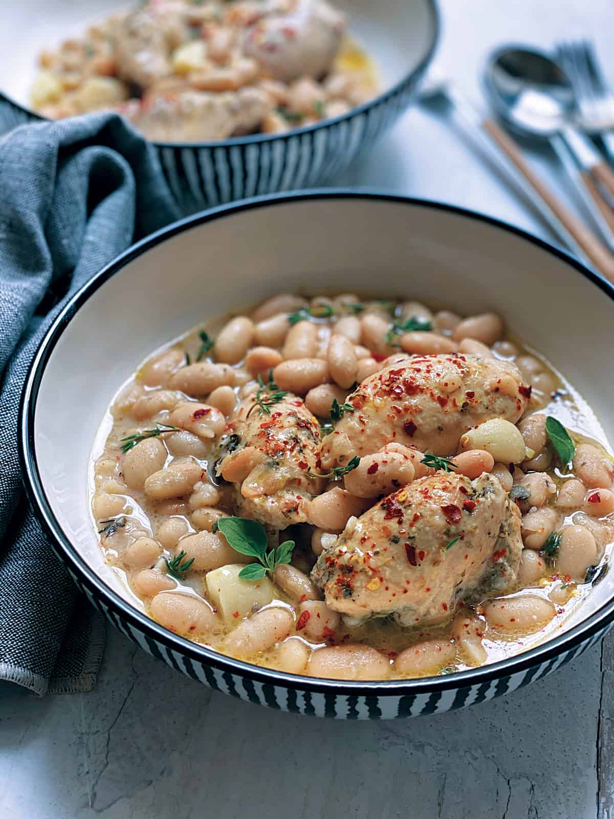 Two plates with chicken stew with beans