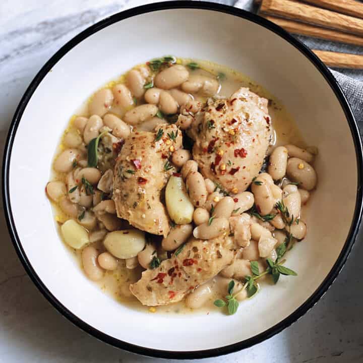 A plate with chicken stew with beans
