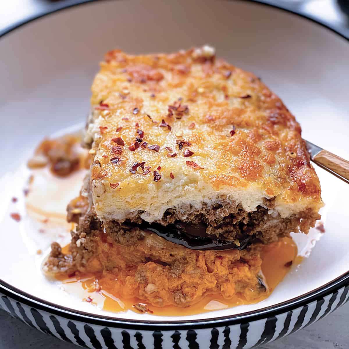 A plate with a piece of sweet potato moussaka.