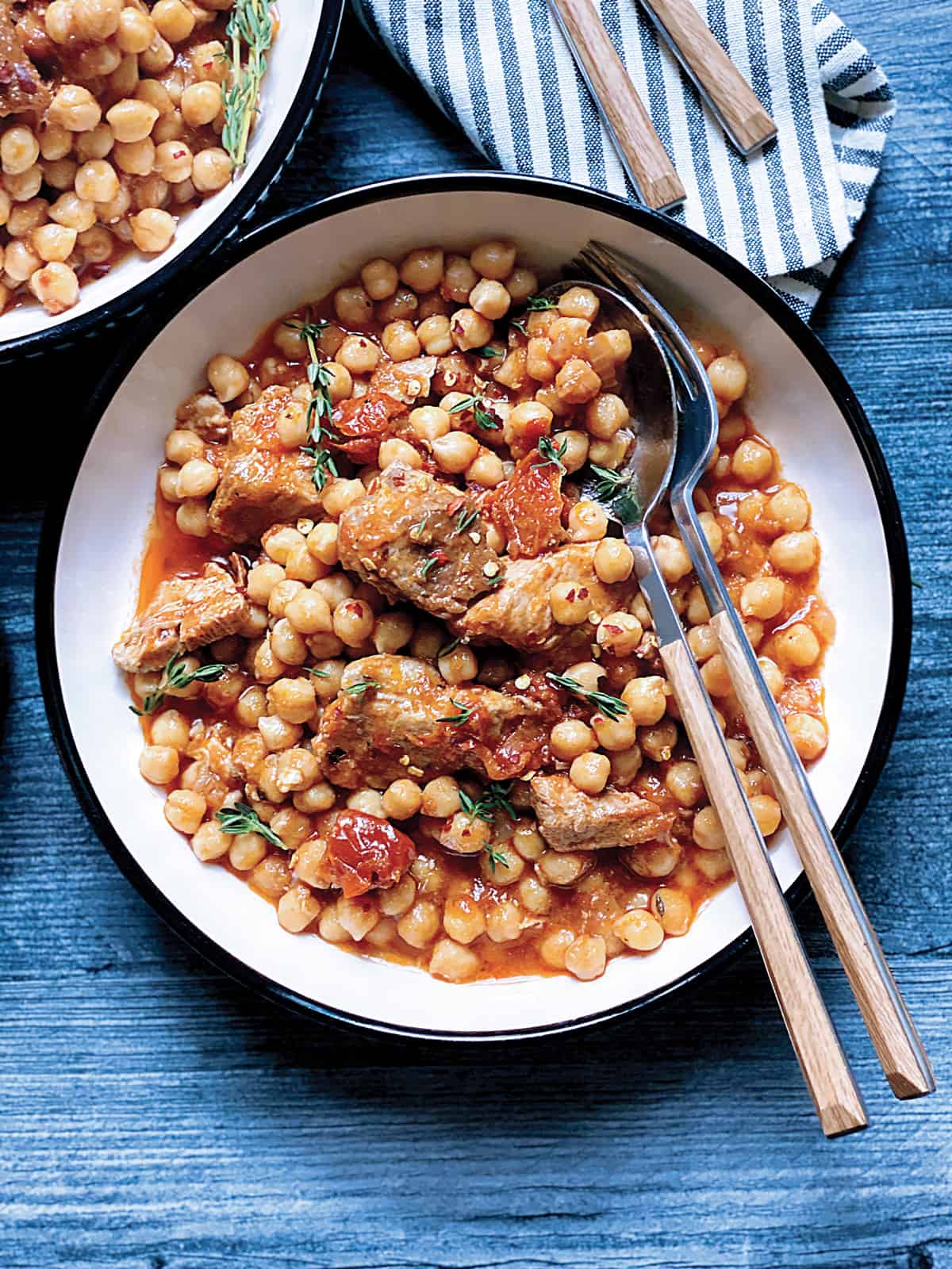 A plate with chickpea and pork stew.