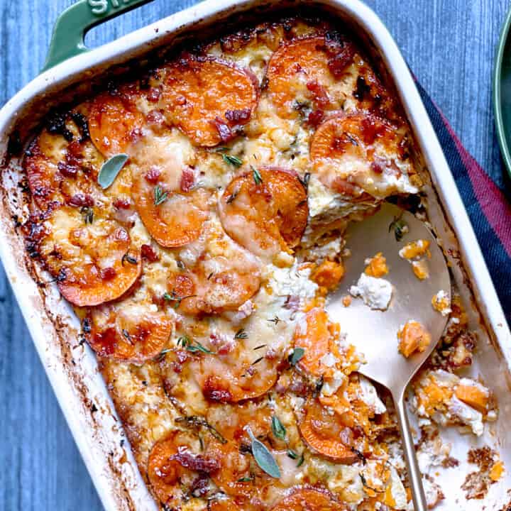 A sweet potato casserole and a serving utensil.