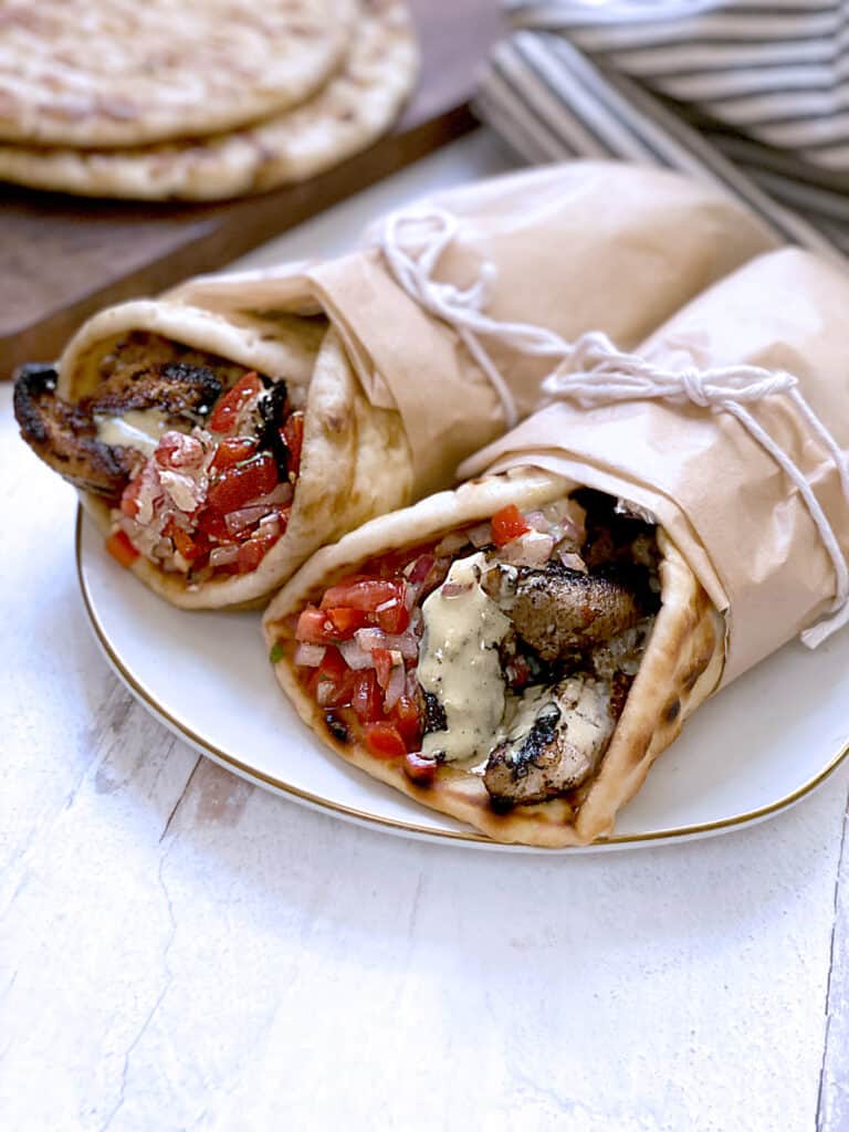 Two gyro souvlaki on a plate.