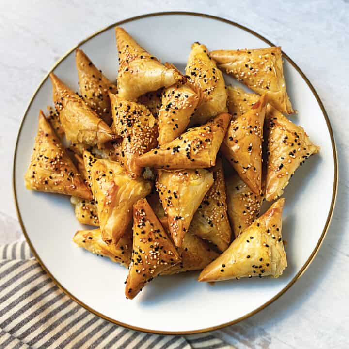 A plate with greek cheese pie triangles.