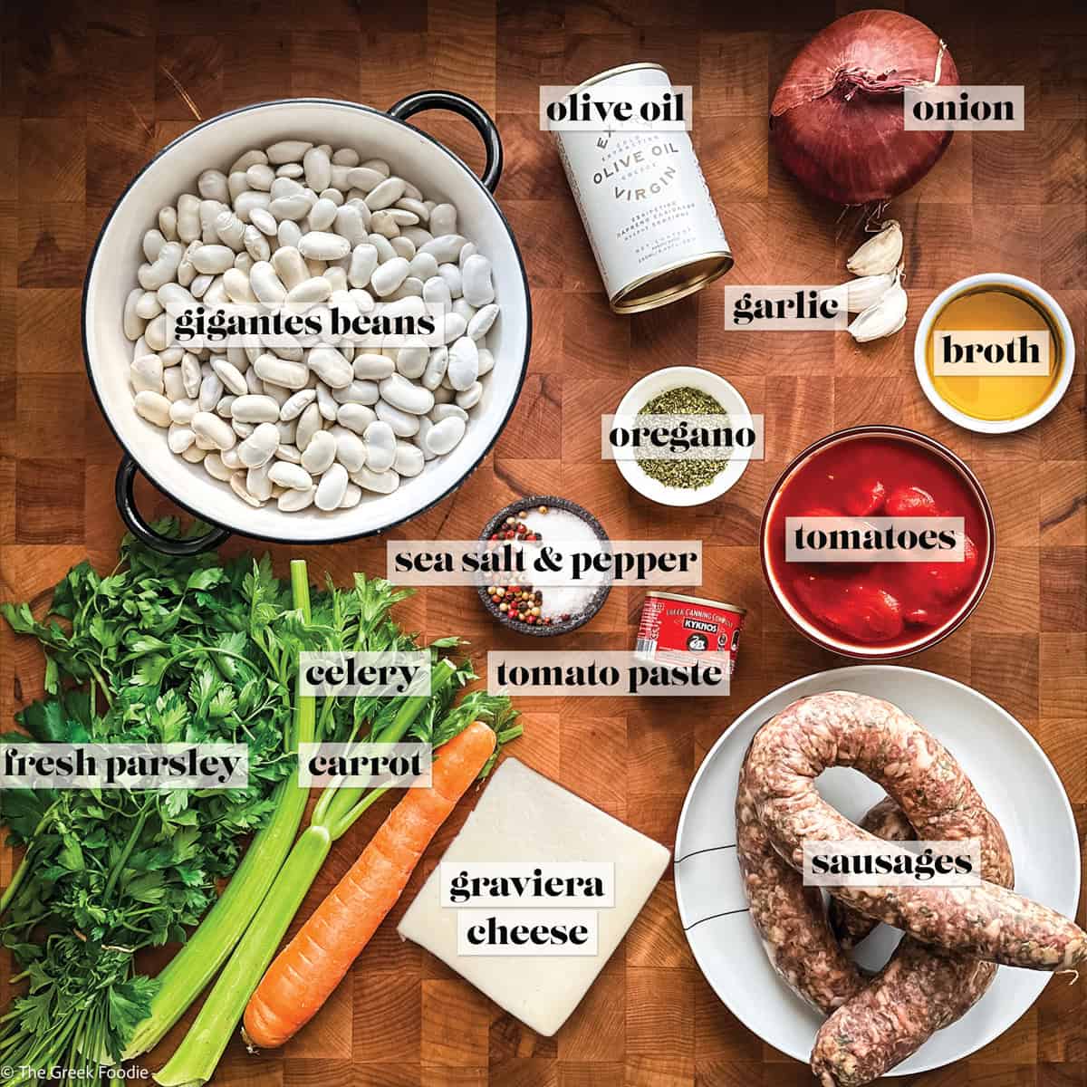 Ingredients to make Greek gigantes beans place on a wooden surface