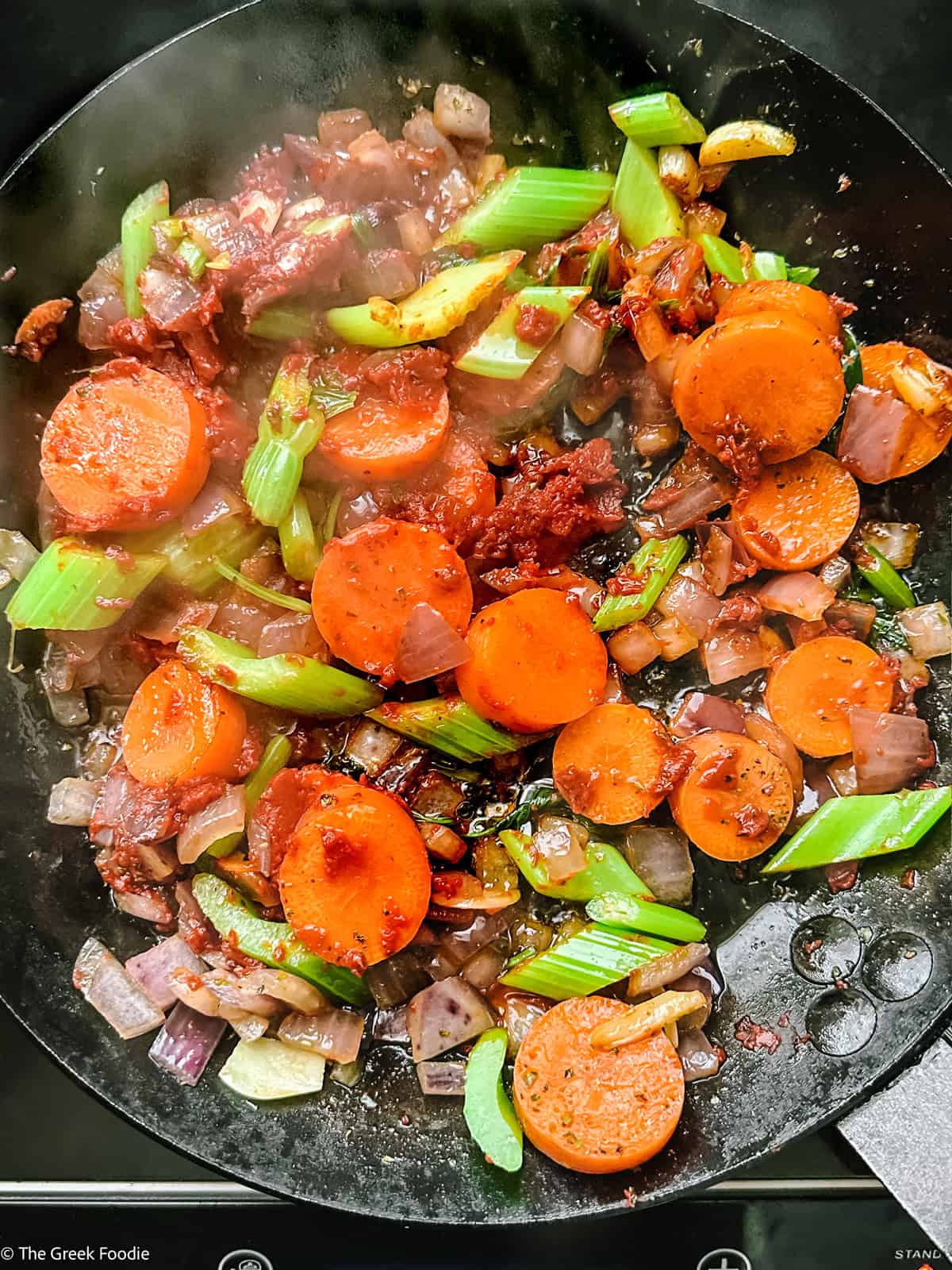 Carrots, celery and tomato paste added to the onion mixture
