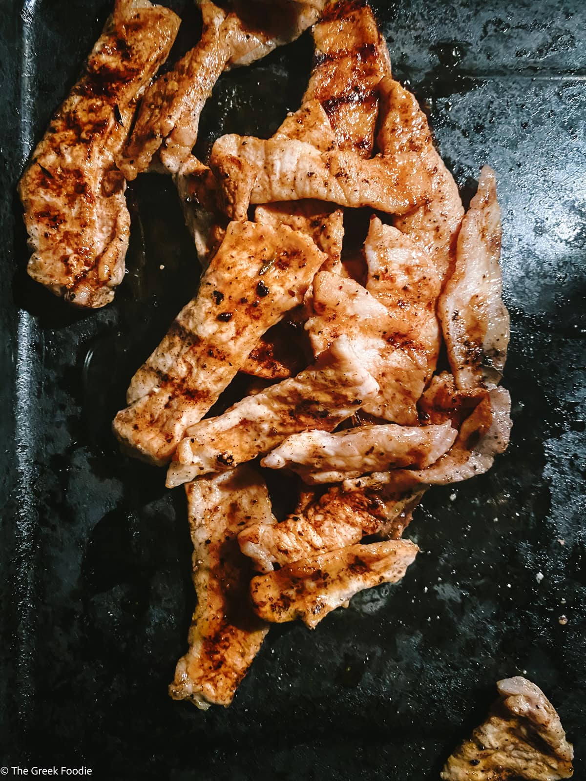 Pieces of pork on a grill.