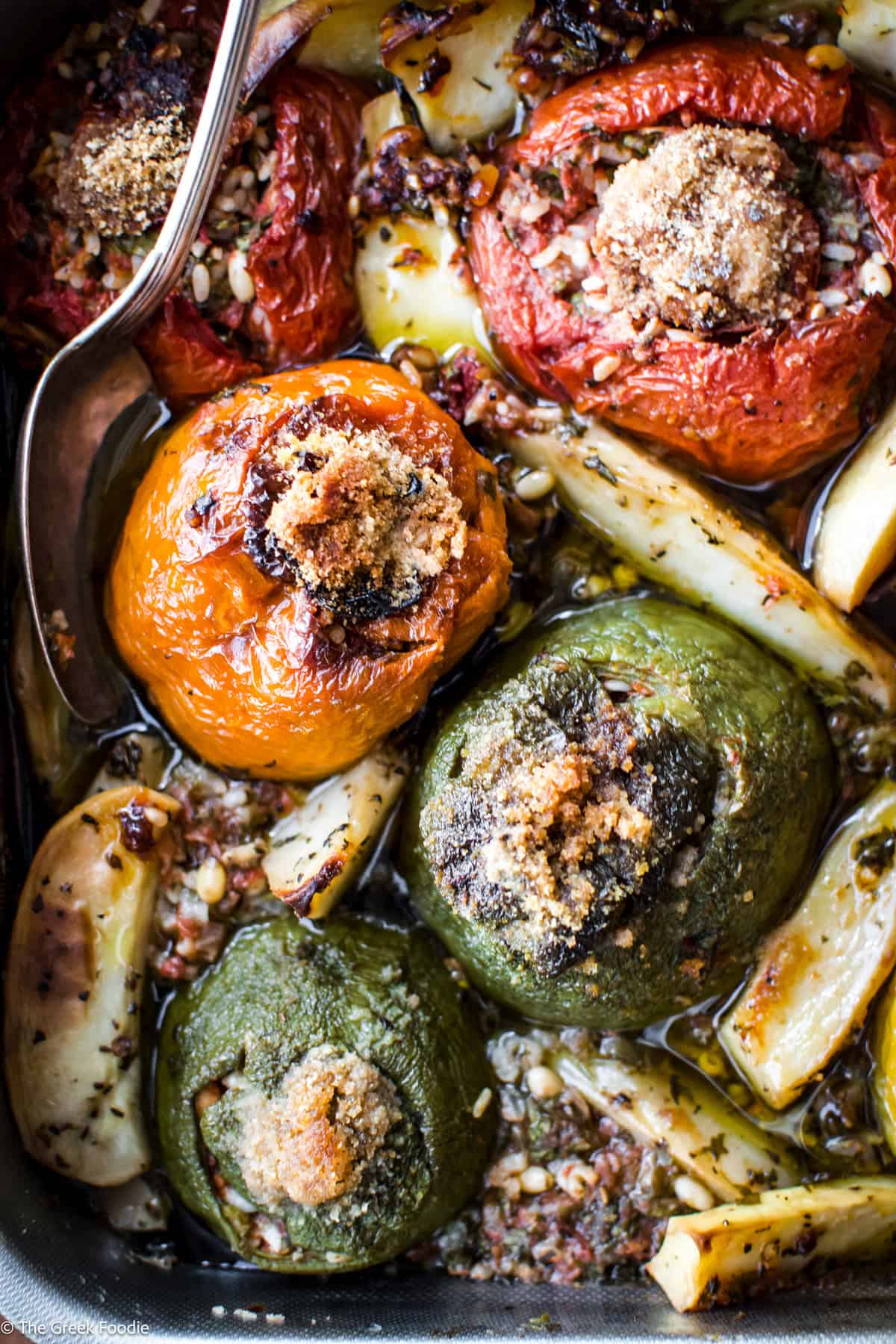 Close-up of golden, caramelized gemista — Greek stuffed tomatoes straight from the oven