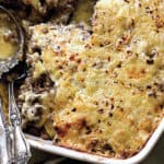 A pan with keto moussaka and two serving utensils.