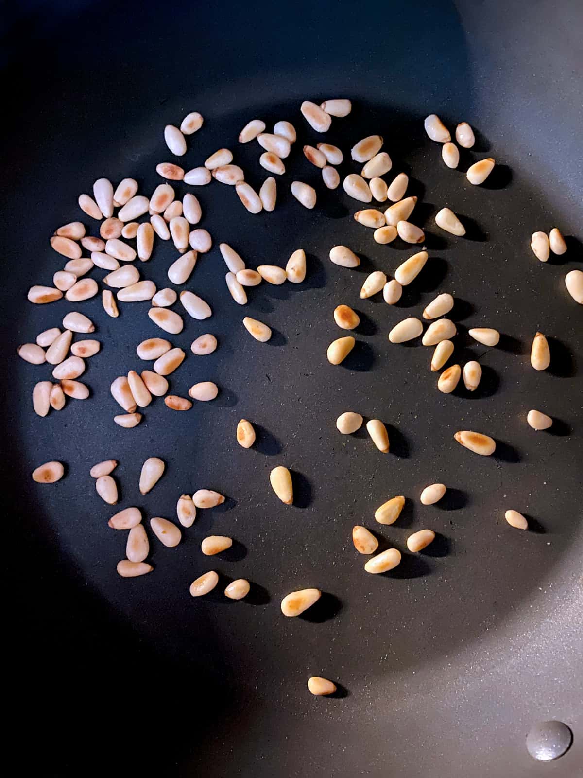 Pine nuts in a pan.