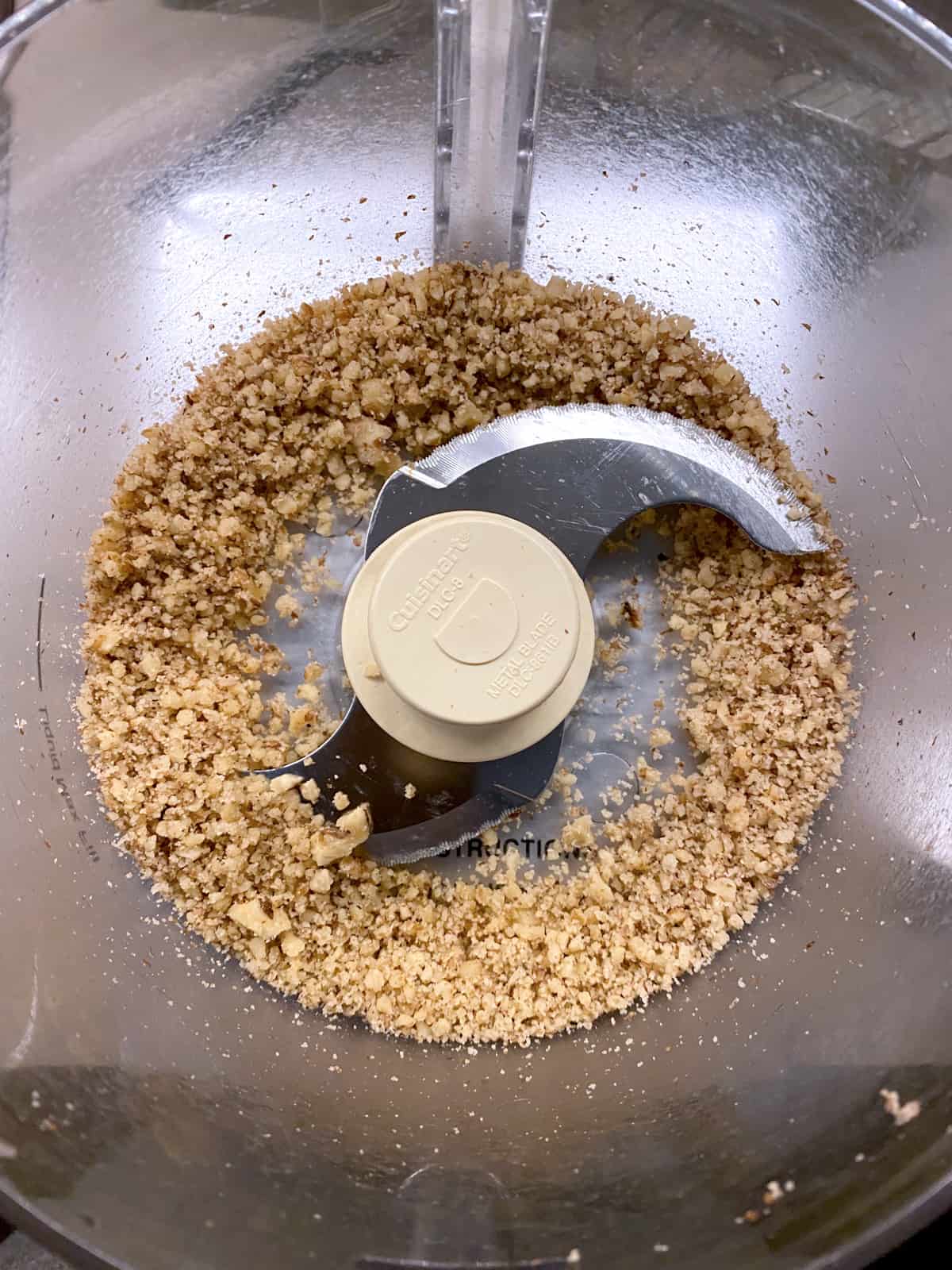 Walnut pieces in a food processor.