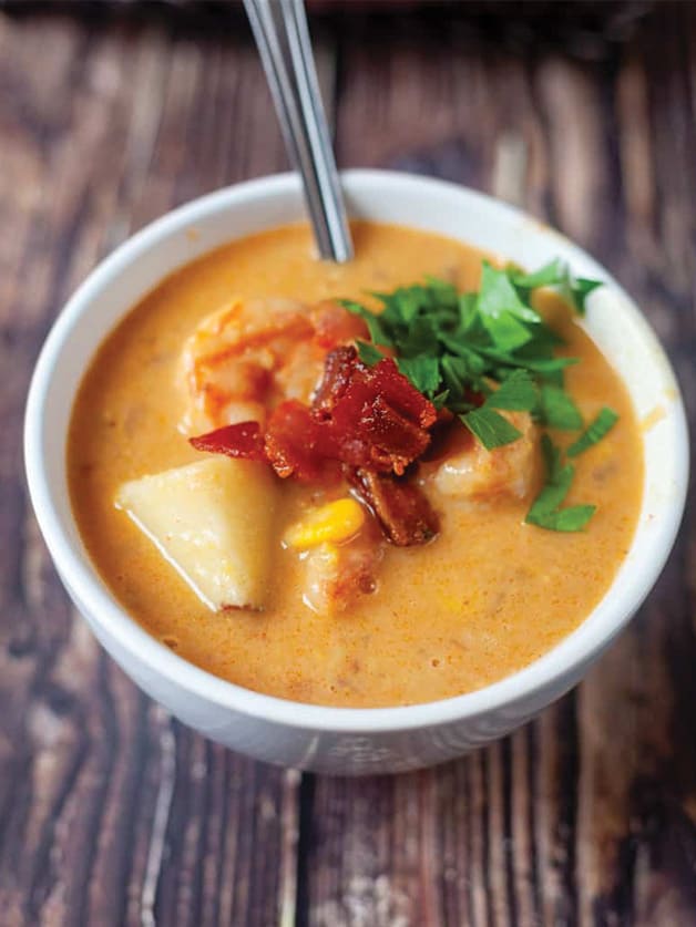 A bowl with Bacon Shrimp Corn Chowder soup.