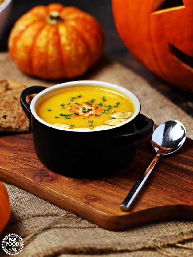 A bowl with curried pumpkin soup with coconut milk.