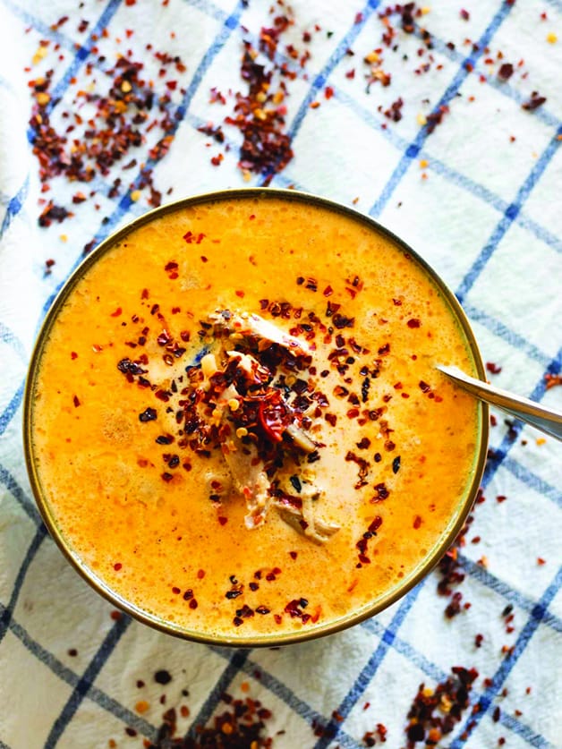 A bowl with spicy chicken soup.