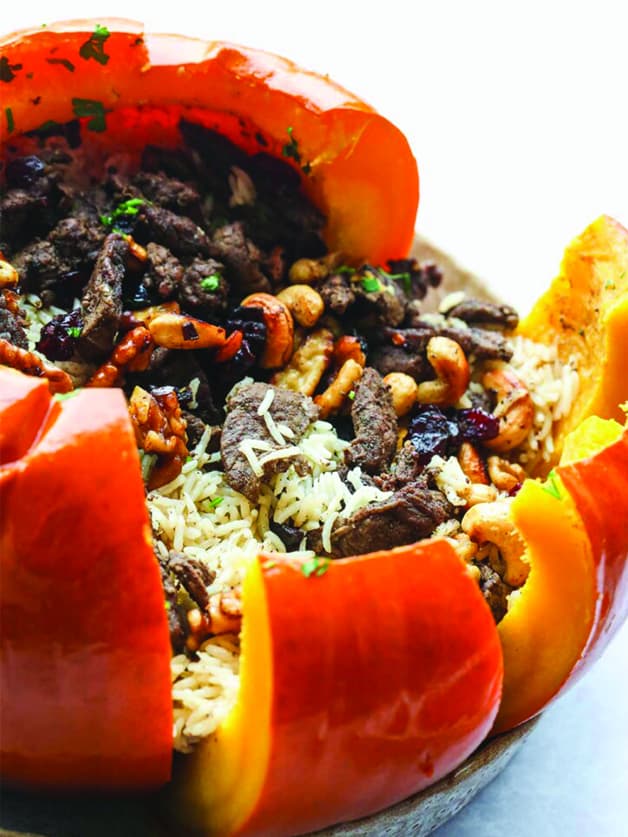 A stuffed pumpkin with rice ground beef and veggies.