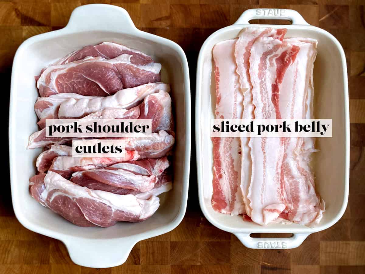 A pan with pork shoulder cutlets next to a pan with sliced pork belly.