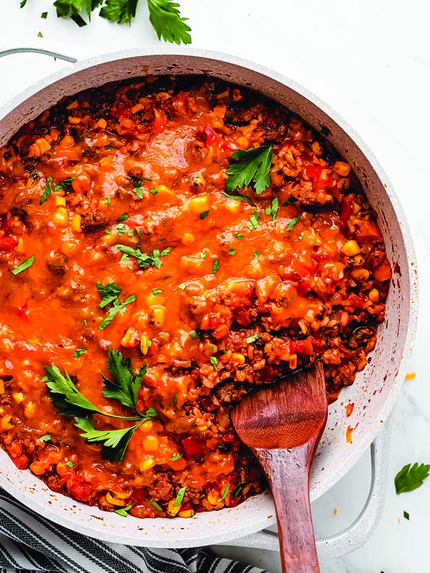 A bplate with ground beef and rice casserole and a spoon.