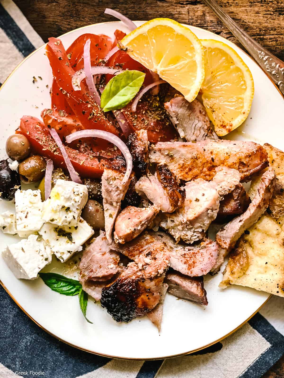 Greek gyros pita with tzatziki, sliced tomatoes, and onions — traditional Greek street food made at home