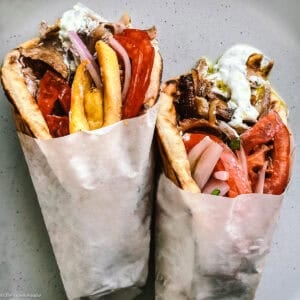 Authentic Greek gyros recipe — pork shoulder and belly served in warm pita with tzatziki, tomatoes, and fries