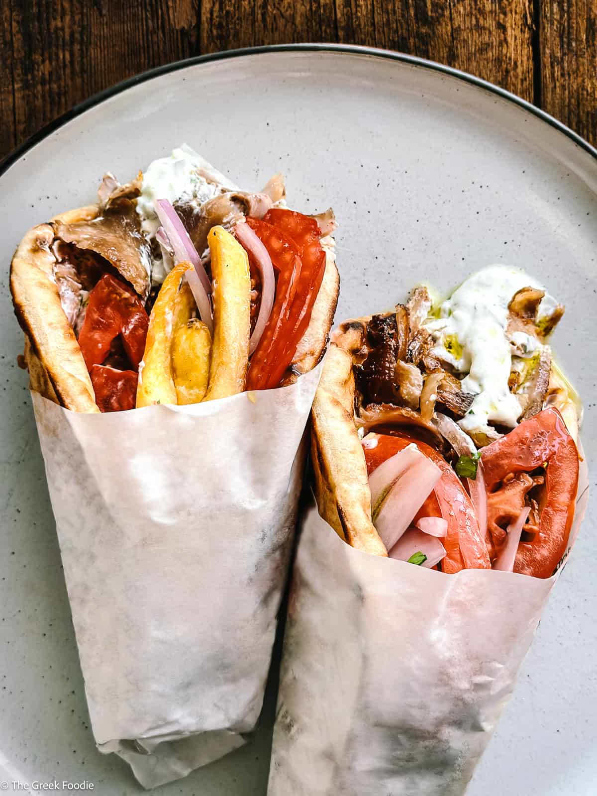 Authentic Greek gyros recipe — pork shoulder and belly served in warm pita with tzatziki, tomatoes, and fries