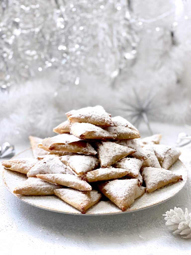 Trigona almond phyllo triangles on a holiday serving plate.