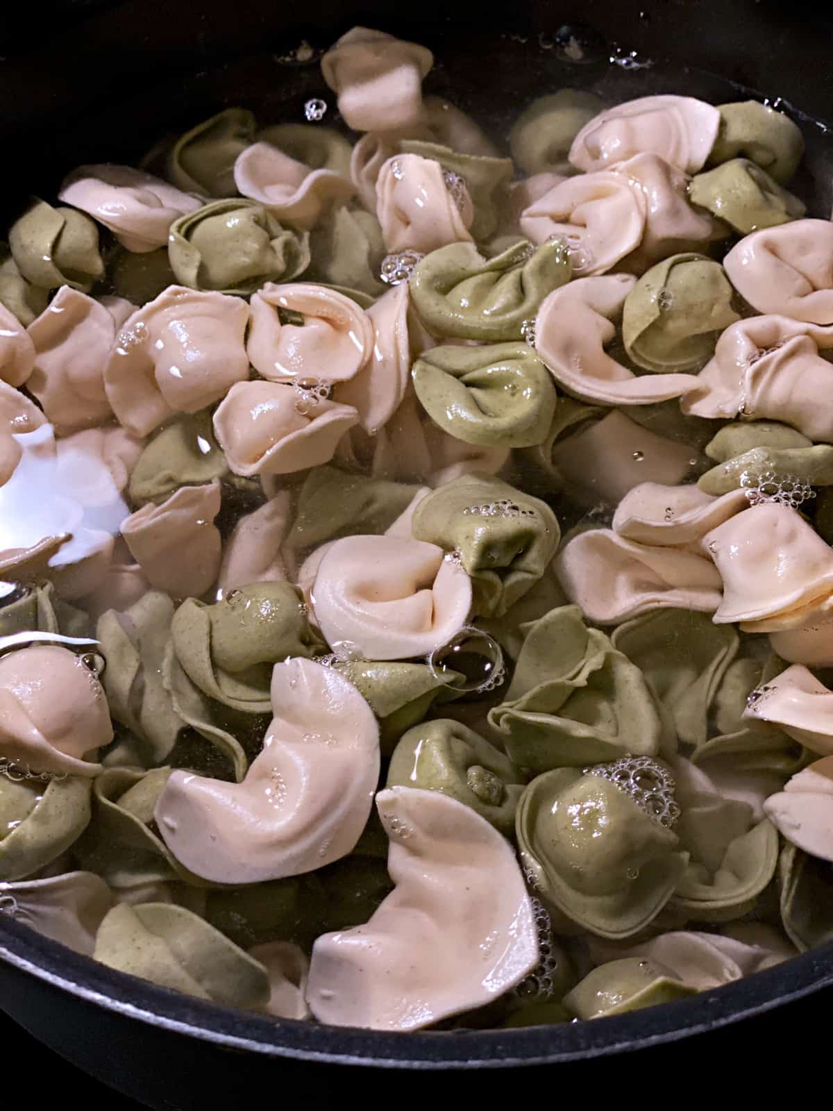 Tortellini pasta in water boiling.