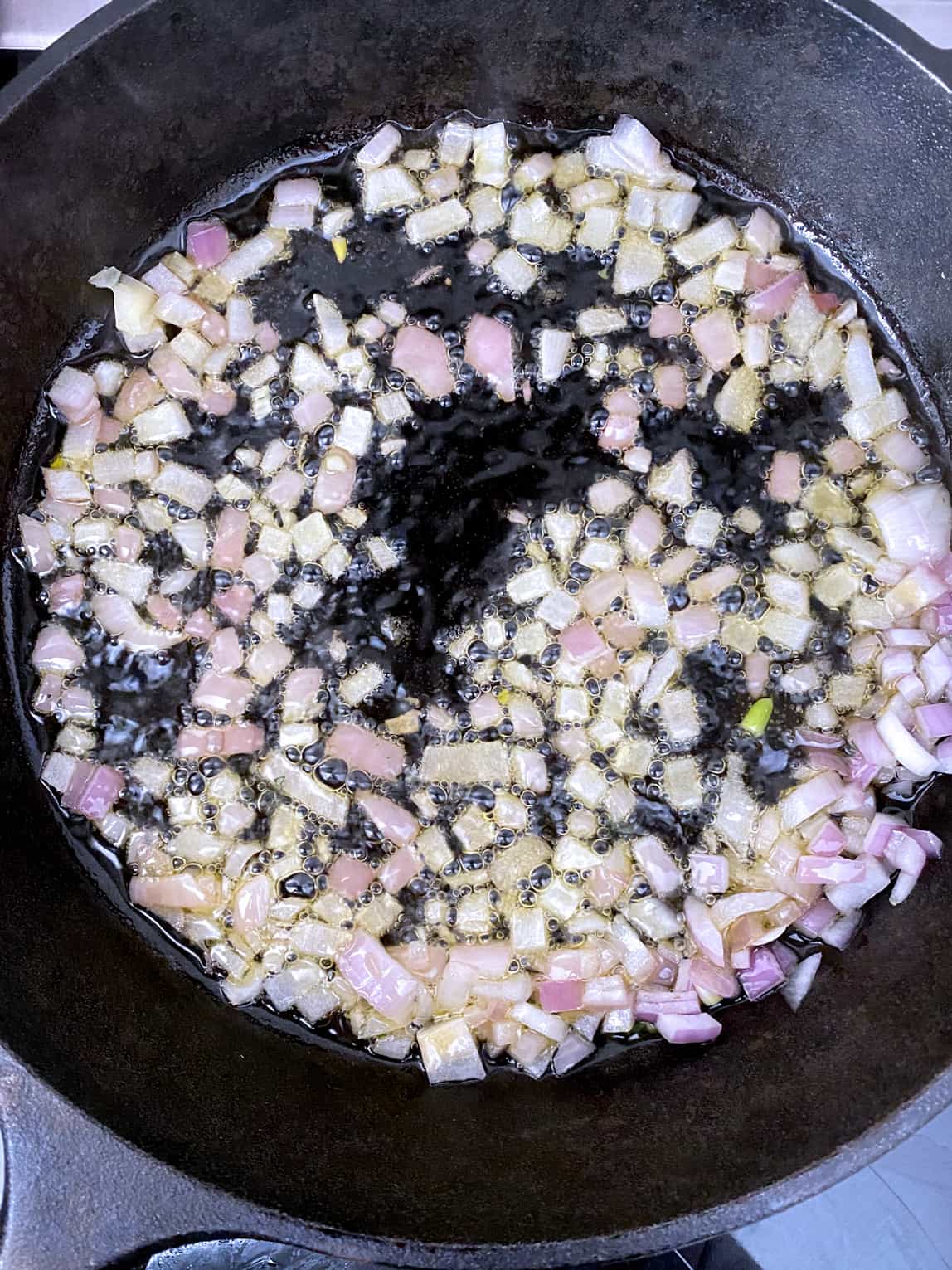 Onions sautéing in a skillet.