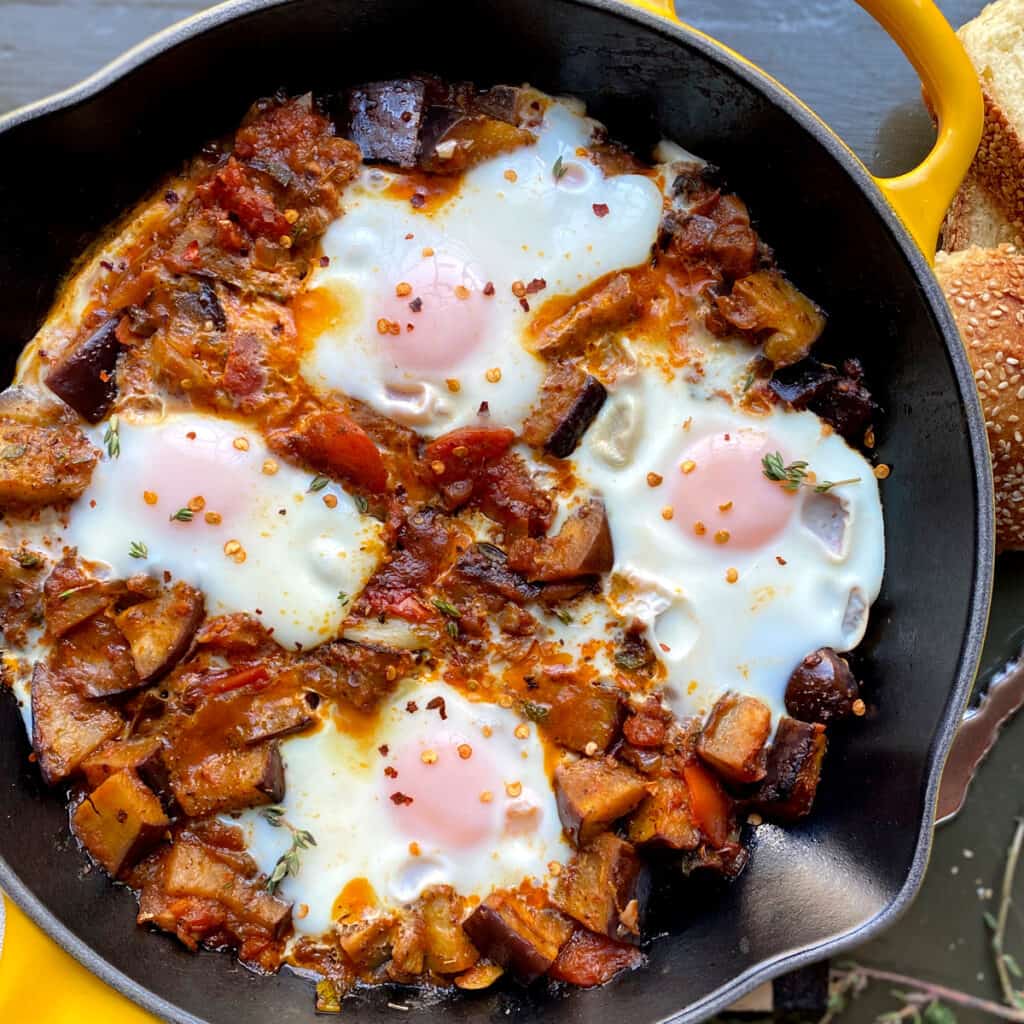 Eggplant Shakshuka in a yellow skillet.