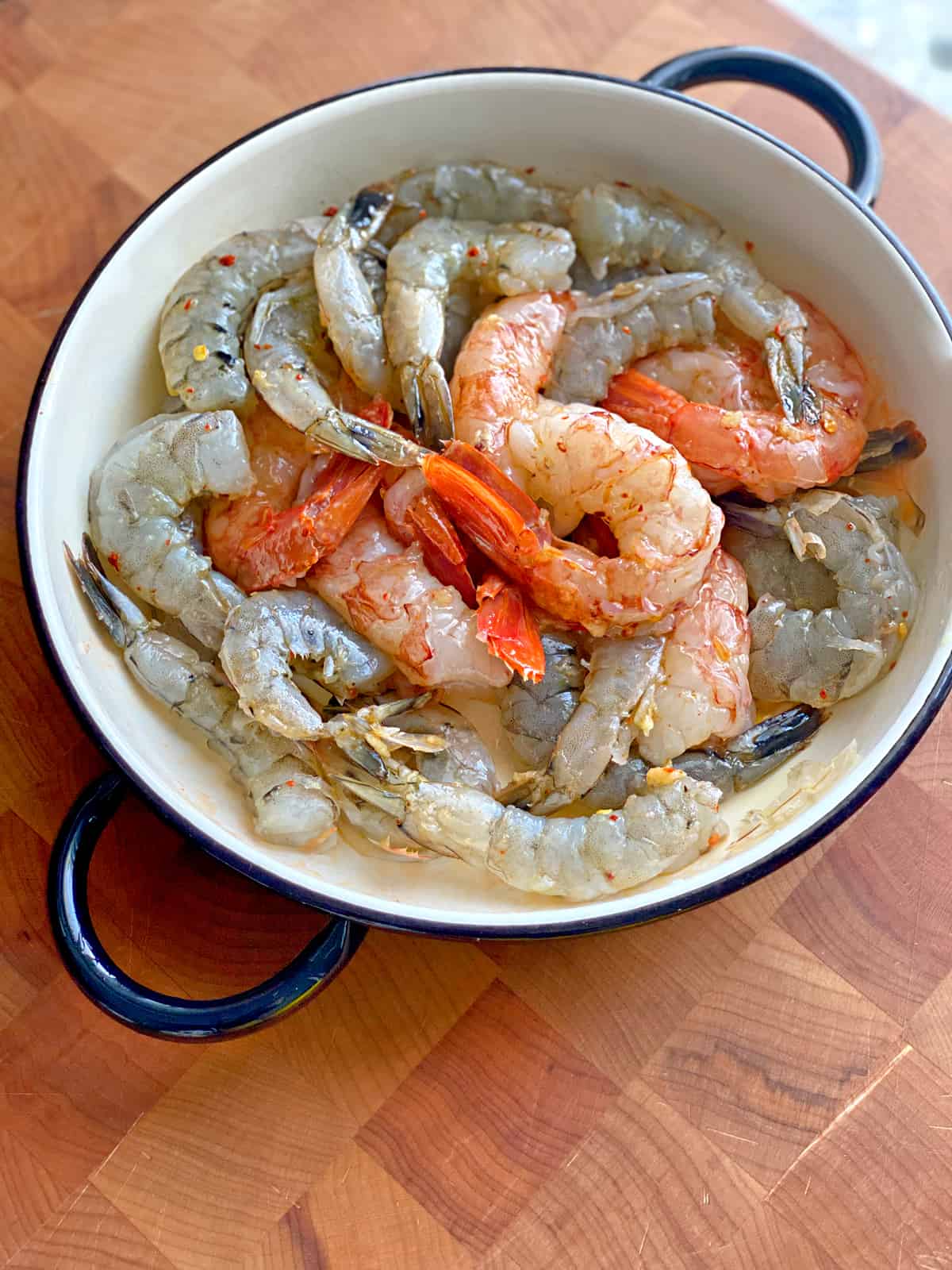 Raw shrimp in a bowl marinating.