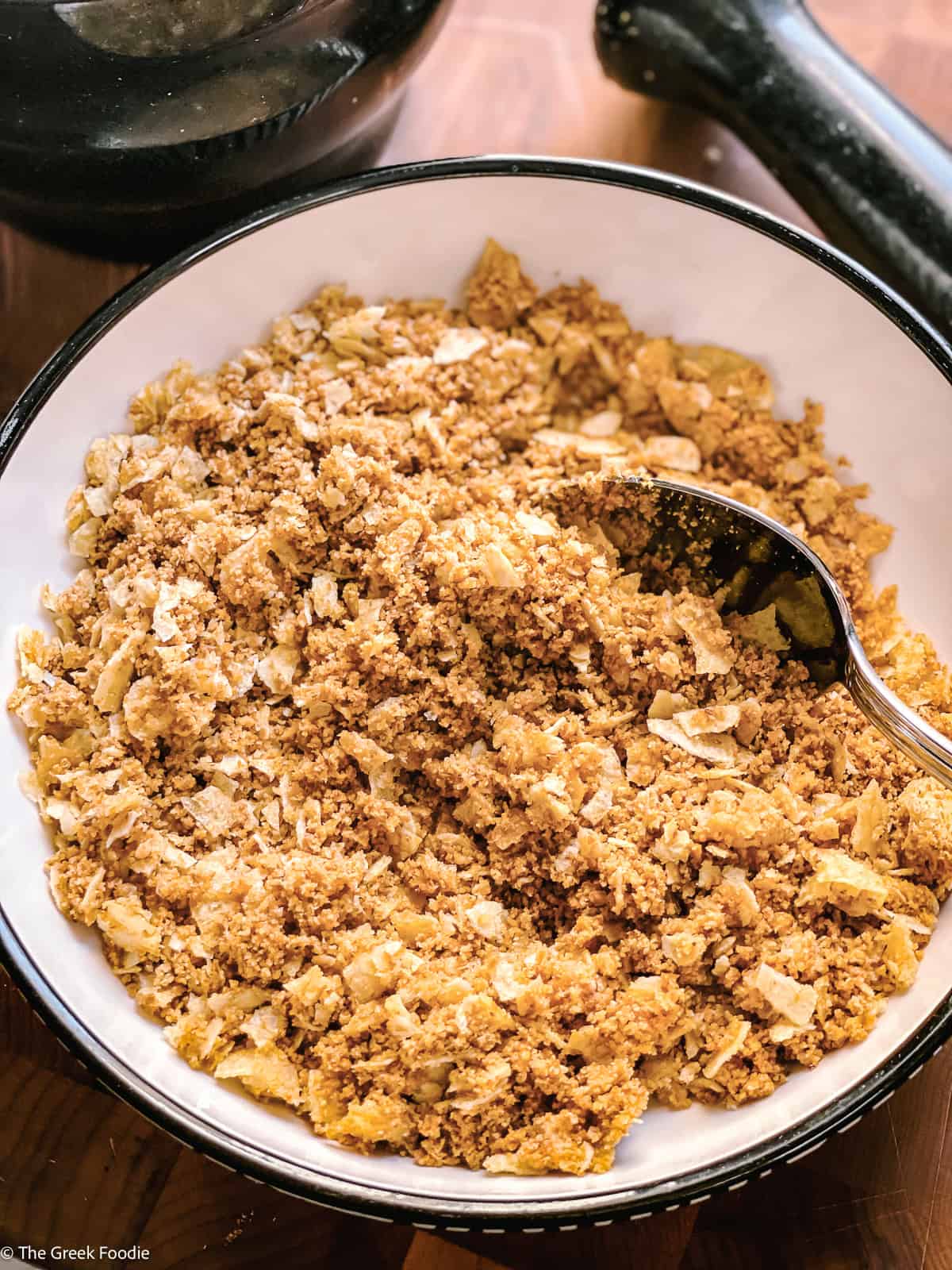 Close-up of the creamy potato fritter mixture showing herbs, scallions, and chili flakes throughout.
