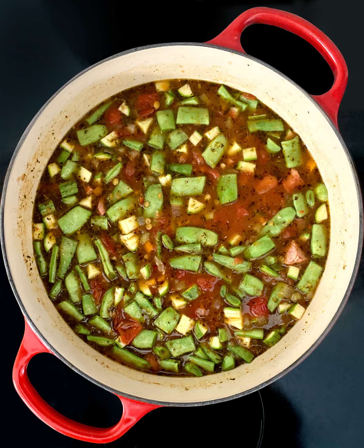 Cut up beans and tomato broth with olive oil in a stockpot.