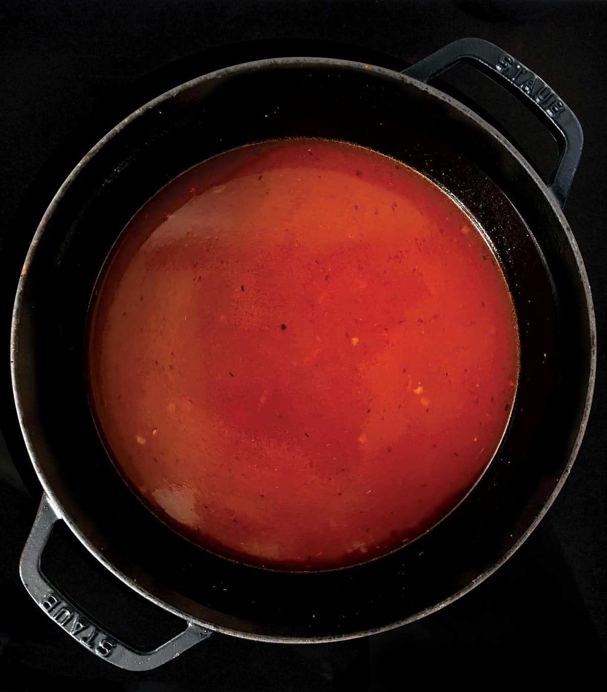Tomato broth in a stockpot.
