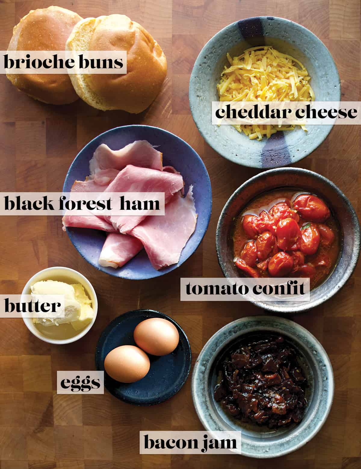 Ingredients for making fried egg sandwich on a butcher block.