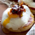 A brioche bun with ham and a fried with bacon jam on top.