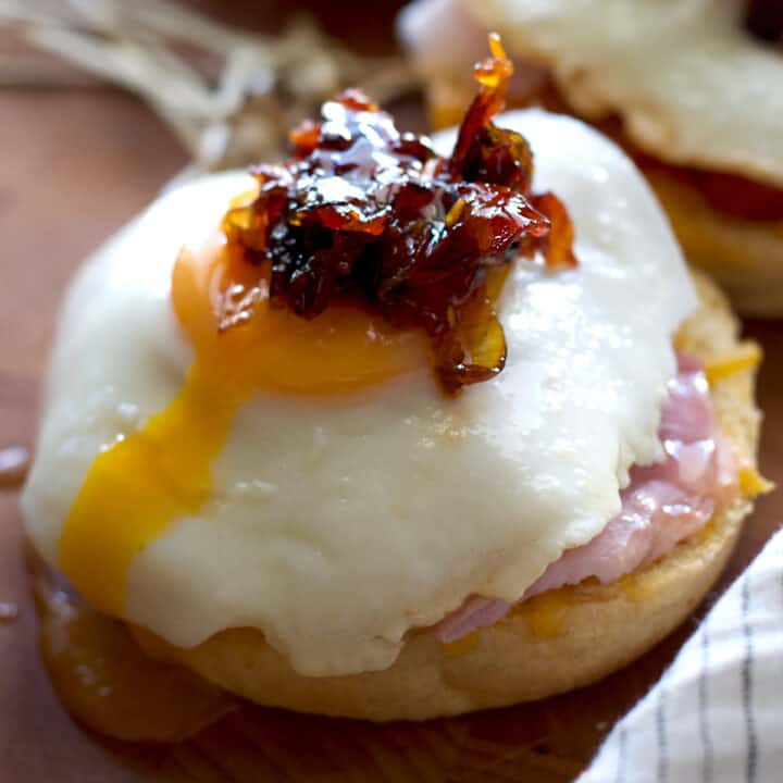 A brioche bun with ham and a fried with bacon jam on top.