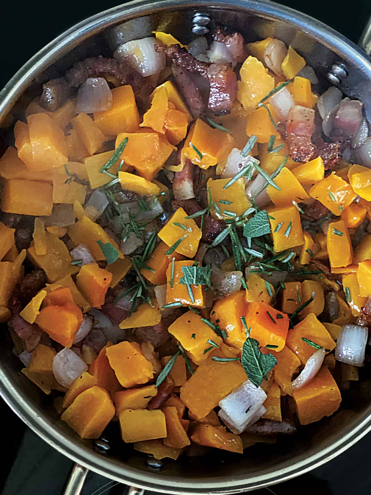 Pumpkin cubes and guanciale pieces
chopped onion and garlic in a deep sauce pan.