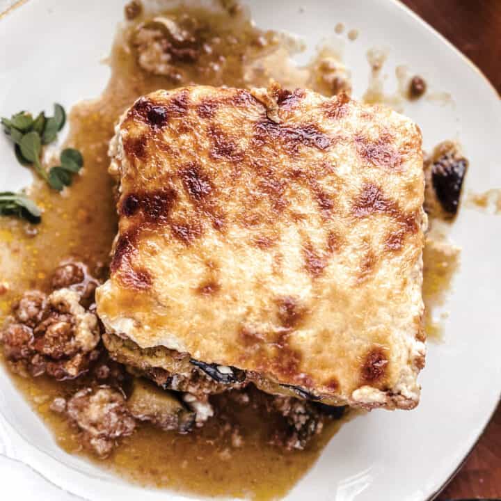 A piece of moussaka on a plate.