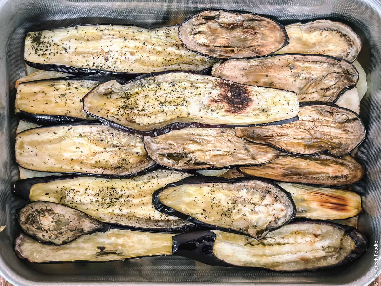 A layer of eggplant slices in a baking pan for Greek moussaka