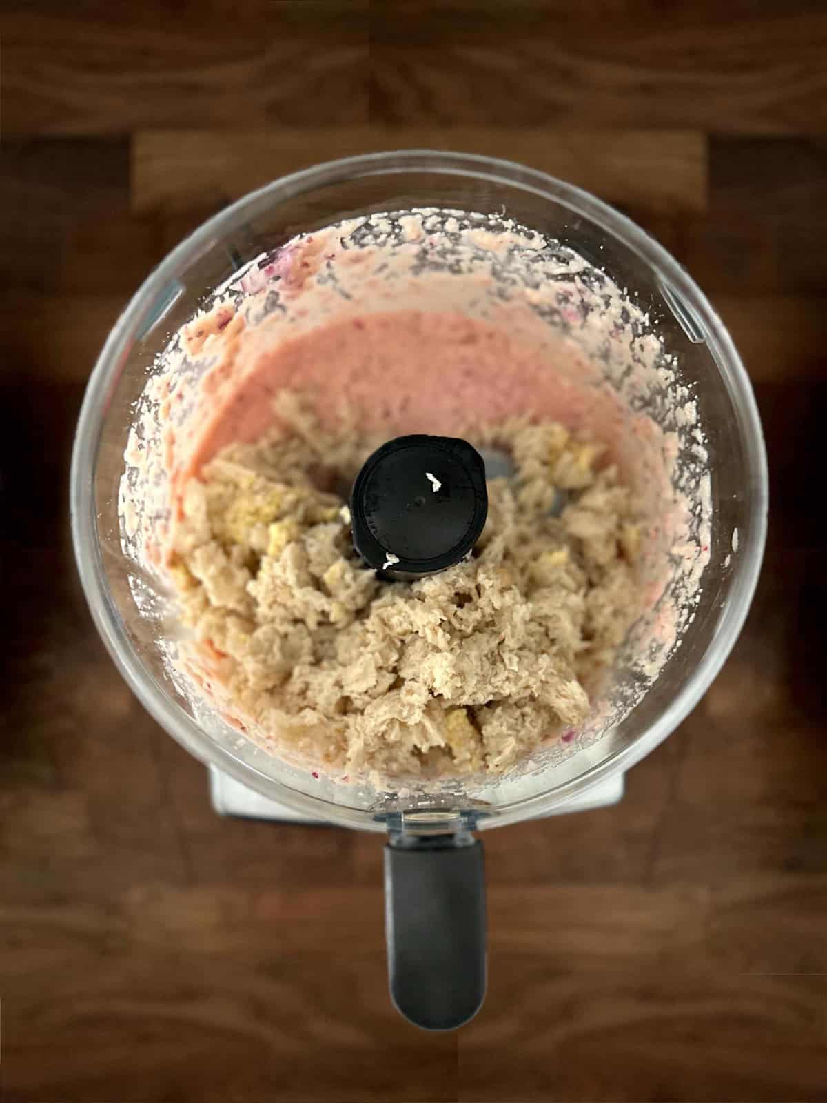 Soaked bread added to food processor with fish roe and onion for taramosalata