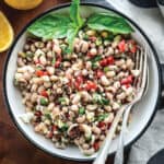 A black eyed pea salad and fresh basil in a plate.