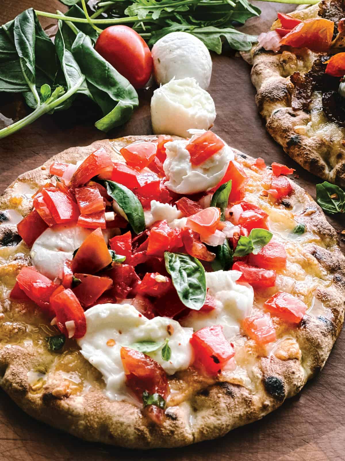 A pita pizza with tomatoes and mozzarella.
