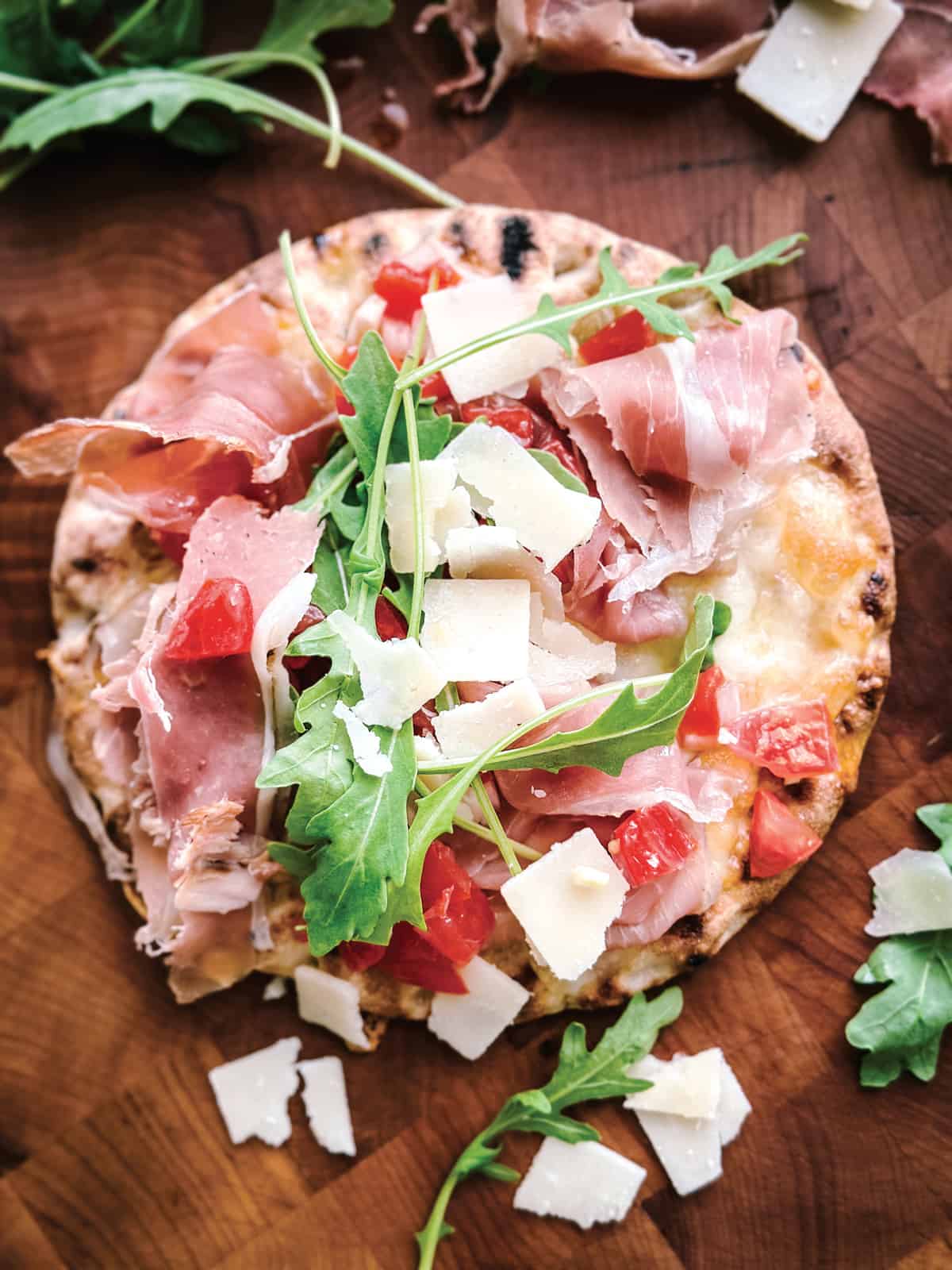 Apita pizza with arugula, prosciutto and parmesan.