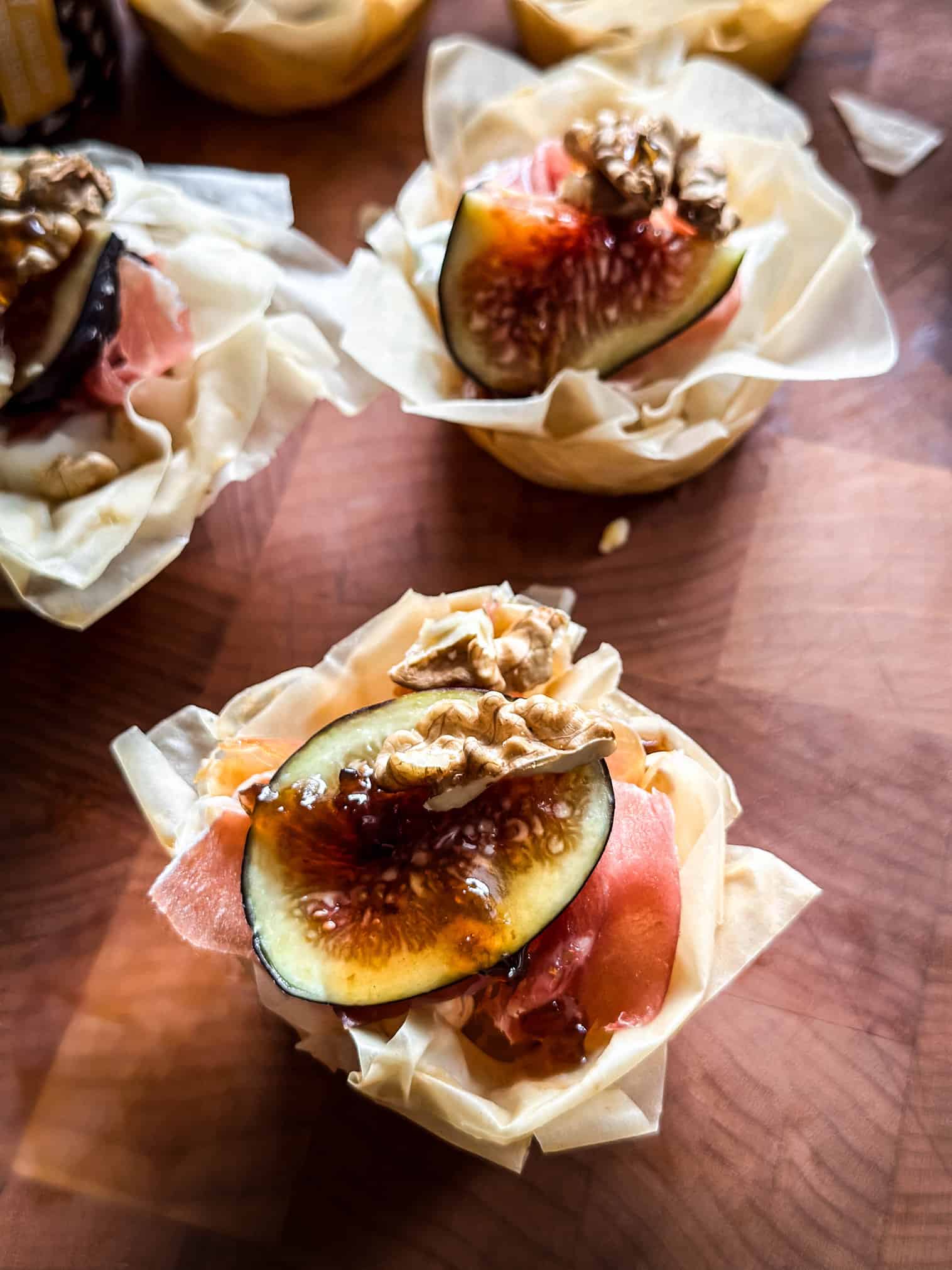 A phyllo cup appetizer with fig, walnut and prosciutto.