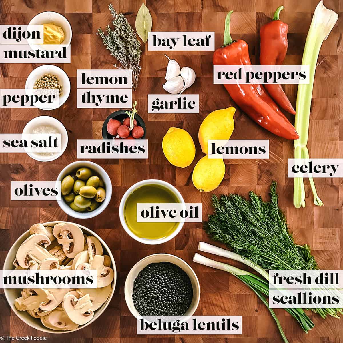 Ingredients to make black lentils salad on a wooden board.