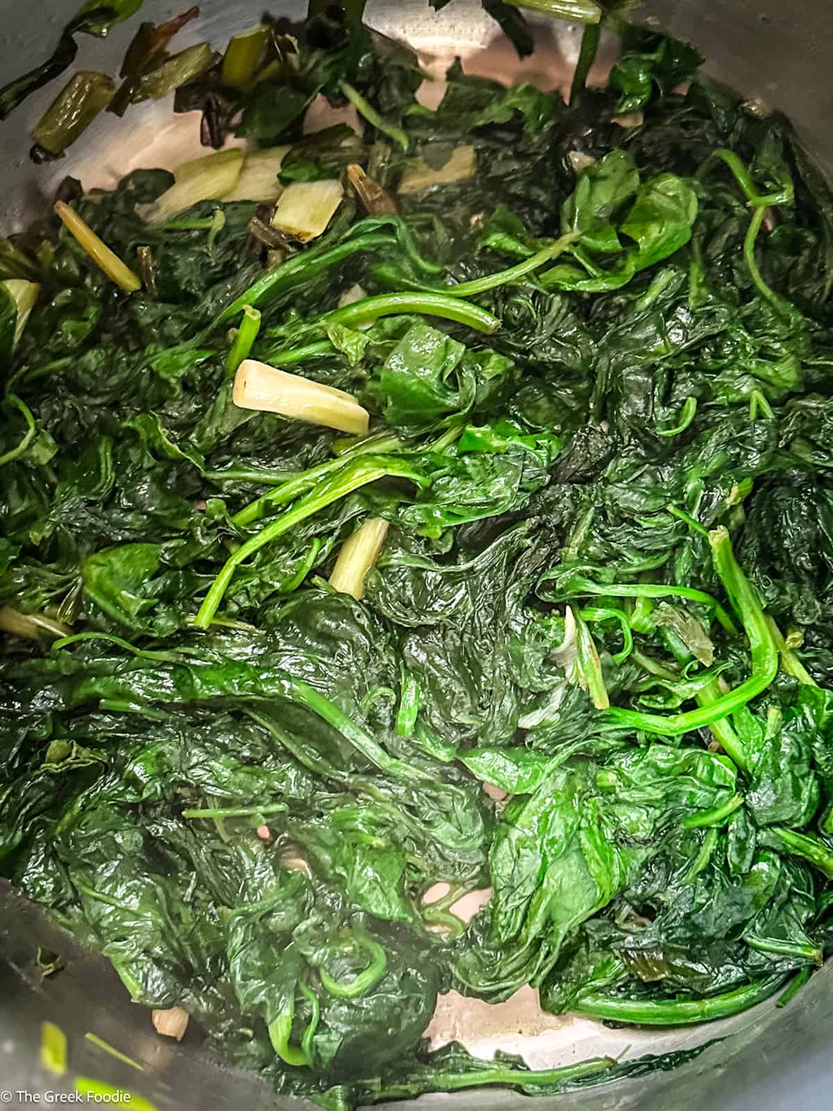 Wilted spinach in a skillet.