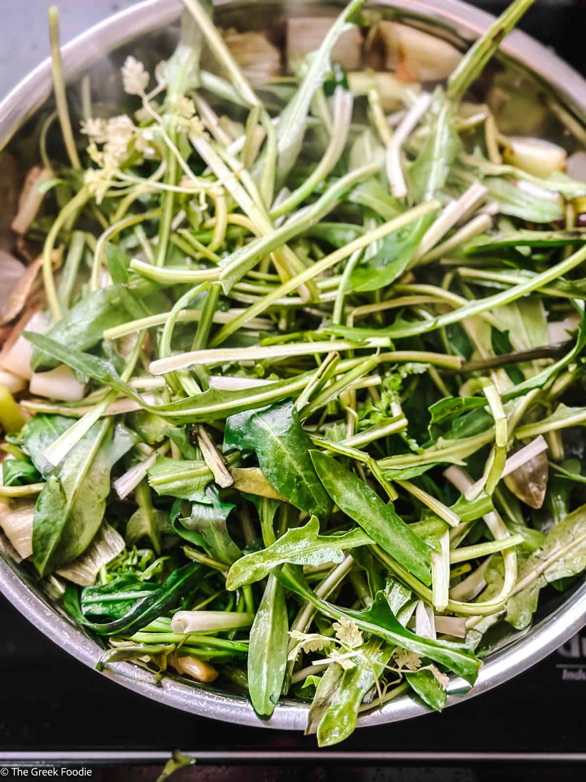 Various greens in a skillet.