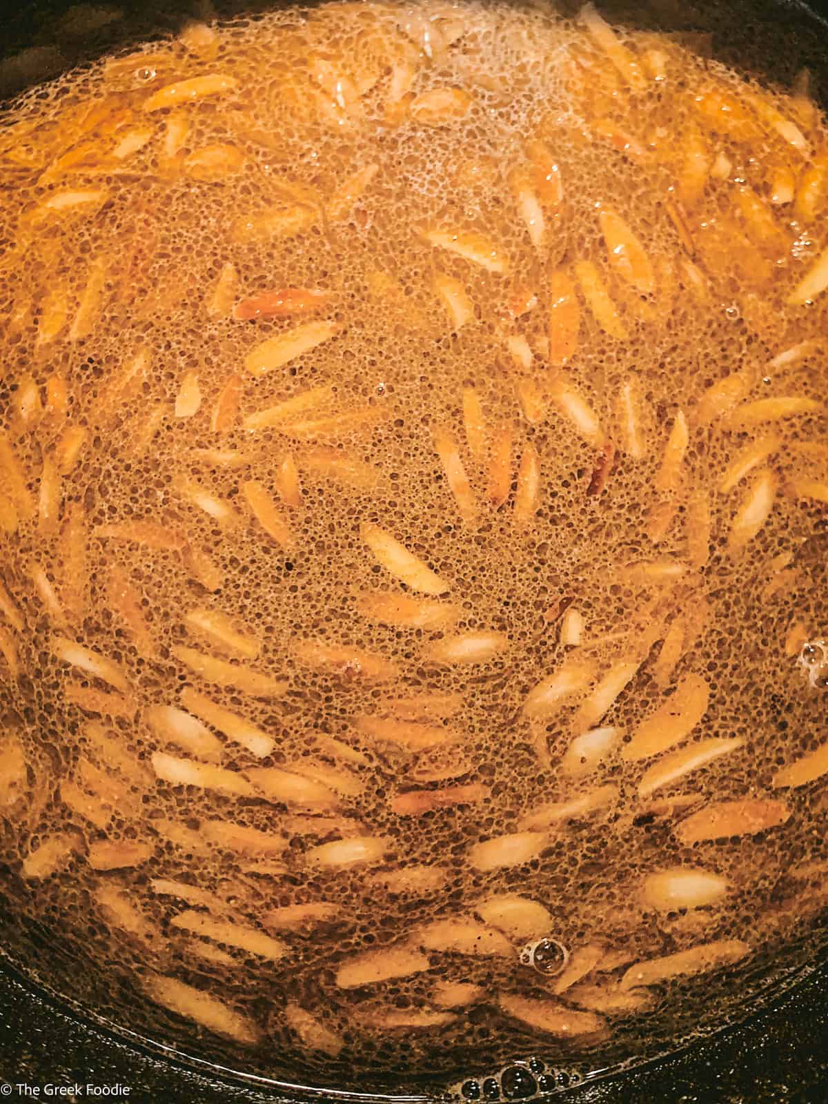 Semolina flour, sugar, slivered almonds and water in a pot.