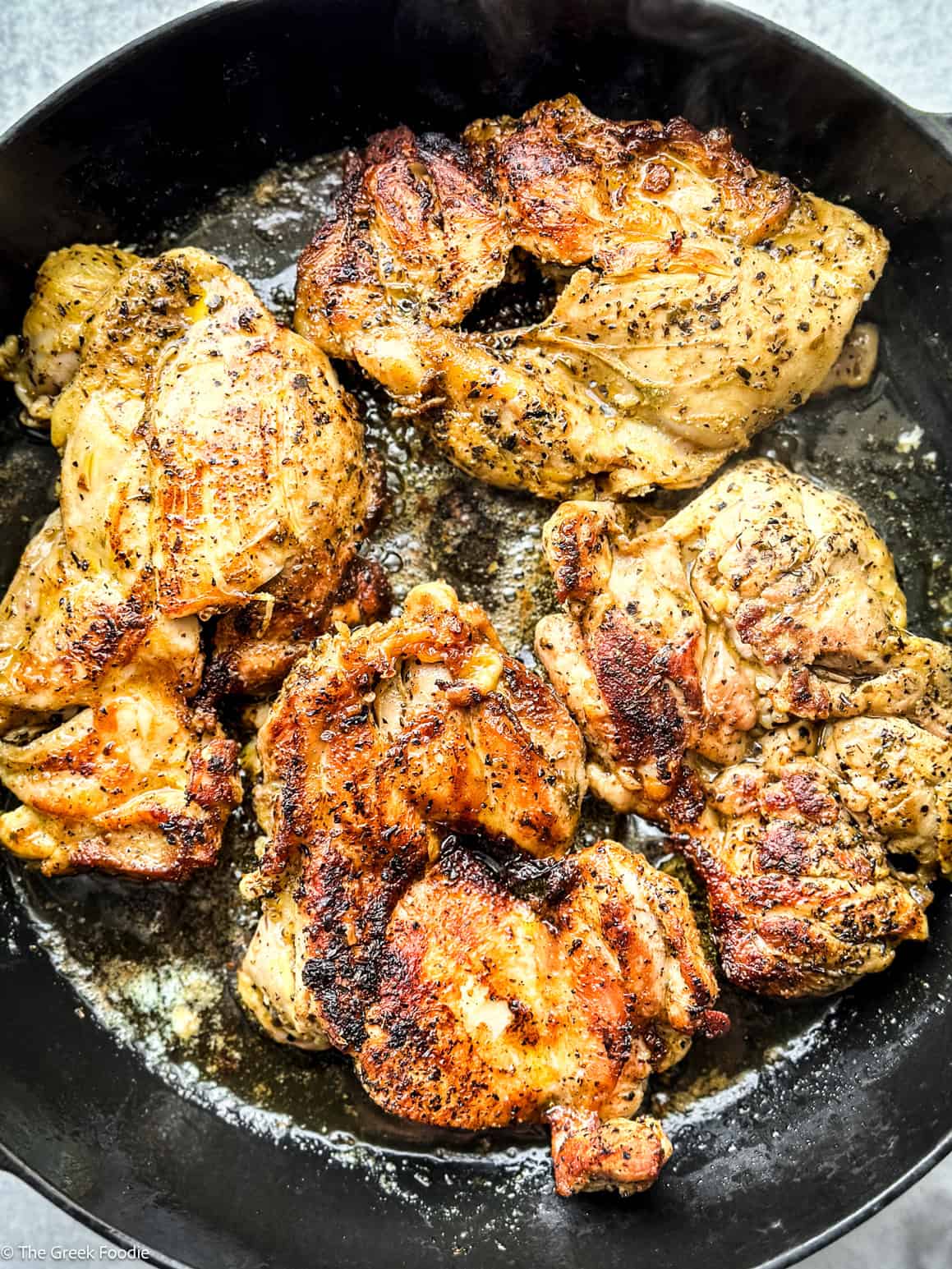 Chicken browning in a skillet.